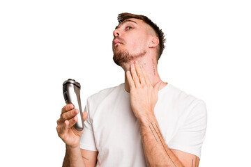 Young caucasian man using an electric shaver isolated cut out