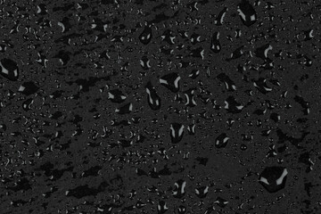 Water drops on dark stone