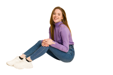 Young redhead woman sitting isolated cut out