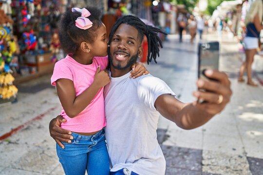 Father and daughter smiling confident make selfie by smartphone at street market