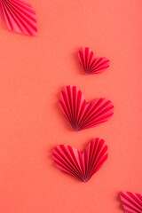 Monochrome red background with origami hearts. Family concept. Vertical view
