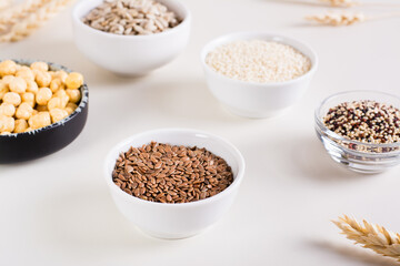 Flax seeds in a bowl and other seeds in bowls on the table. Healthy food.