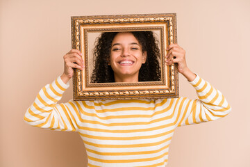 Young african american woman holding a vintage frame isolated