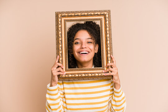 Young African American Woman Holding A Vintage Frame Isolated