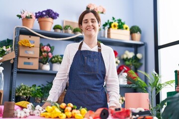 Young woman florist smiling confident standing at florist shop