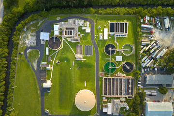 Aerial view of modern water cleaning facility at urban wastewater treatment plant. Purification process of removing undesirable chemicals, suspended solids and gases from contaminated liquid