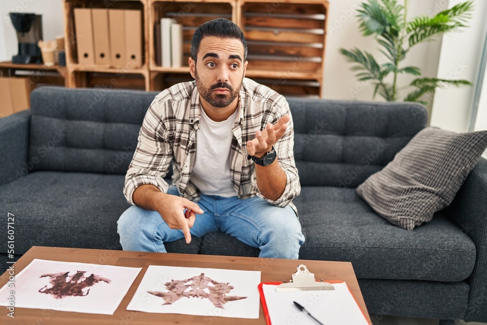 Canvas Prints Young hispanic man patient having rorschach test at psychology center