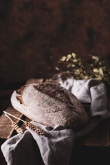 Fresh bread and table cloth on wooden table. Bakery still life and bread at wood tabletop