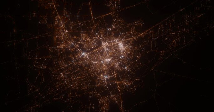 Las Cruces (New Mexico, USA) top view at night. Aerial view on modern city from space. Camera is flying above the city, moving forward. Vertical video. The north is on the left side