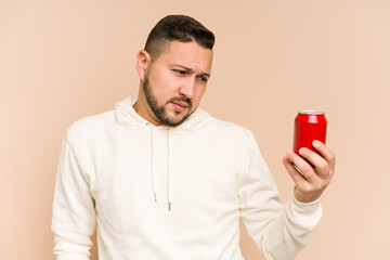Adult latin man drinking cola refreshment isolated