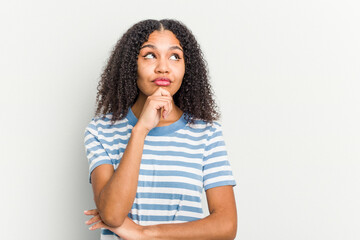 Young african american woman isolated on white background looking sideways with doubtful and skeptical expression.