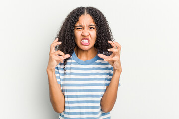 Young african american woman isolated on white background upset screaming with tense hands.