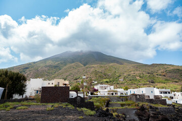 Stromboli Island - Traditional White Houses with Volcano and Smoky Sky"