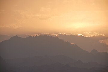 Sunset landscape with dark mountain peaks in egyptian desert