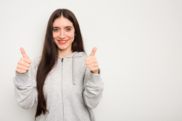Young caucasian woman isolated on white background smiling and raising thumb up