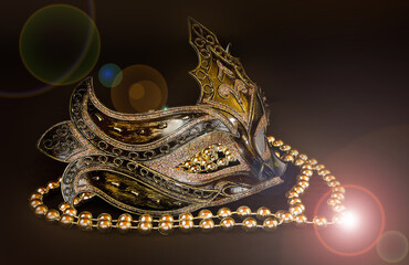 Beautiful carnival mask with beads on a dark background.