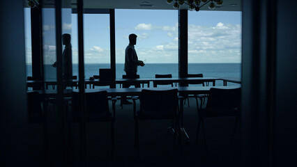 Man silhouette relaxing sea panorama window. Business lifestyle concept