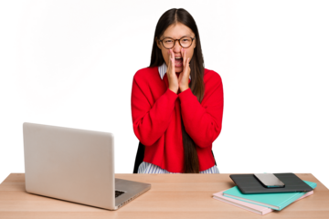 Young student asian woman in a workplace with a laptop isolated shouting excited to front.