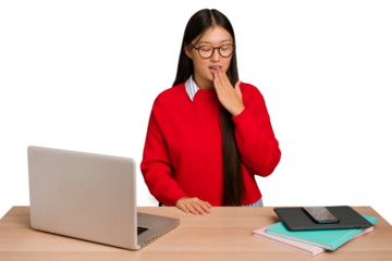 Young student asian woman in a workplace with a laptop isolated yawning showing a tired gesture covering mouth with hand.
