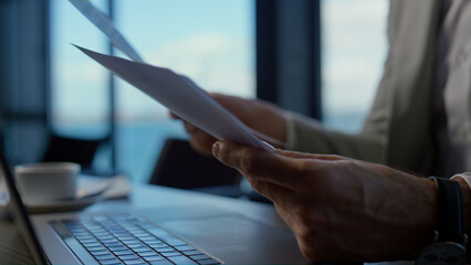 Businessman hands holding papers in marine view office. Director with reports
