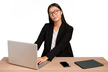 Young asian business woman working in his workplace isolated