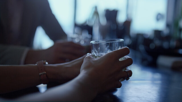 Couple hands drinking gin tonic in bar closeup. Unknown man woman dating in cafe