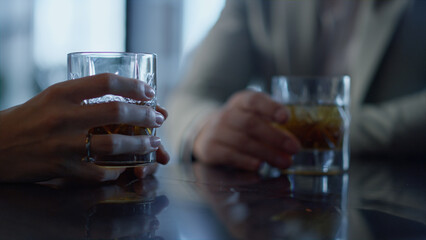 Colleagues hands drinking whiskey in restaurant closeup. Informal meeting
