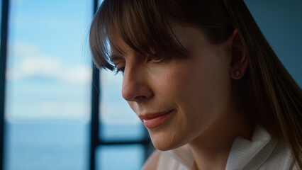 Closeup focused businesswoman working at panorama window. Tired worker leaving