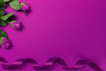 Fillet roses and ribbon lie on a purple monochromatic background Valentine's Day