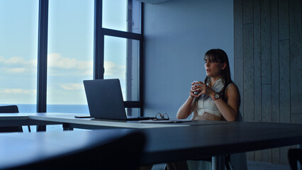 Stressed woman overworking alone in office. Tired manager looking laptop lean