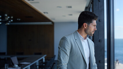 Confident businessman watching sea view. Ceo thinking analyzing and waiting