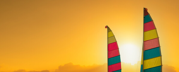 Two colorful sails at sunset. summer vacation background