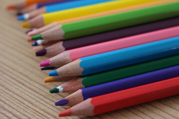 colorful wooden pencils for coloring close up on wooden ground
