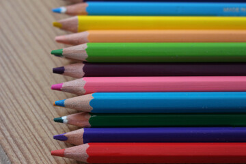 colorful wooden pencils for coloring close up on wooden ground