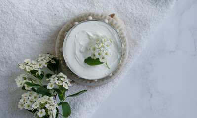 Obraz na płótnie Canvas Cosmetic cream, flower, massage brush on old background