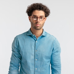 casual man looking at the camera with a gloomy face