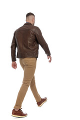 rear view of casual man in brown leather jacket walking away