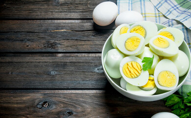 Boiled eggs in a bowl with parsley.