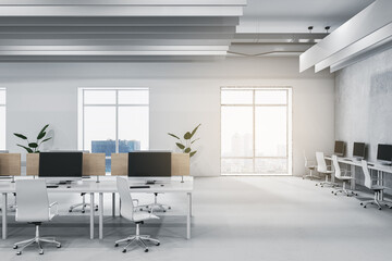 Modern light concrete and wooden coworking office interior with furniture, equipment, window with city view and sunlight. Workplace and loft space concept. 3D Rendering.