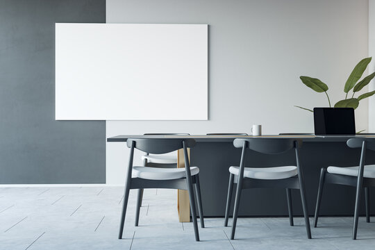 Front view on blank white poster with space for your logo or text on bicolor wall background in modern conference room interior design with dark furniture on concrete floor. 3D rendering, mockup