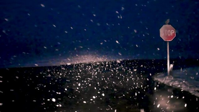 Sitting at a Stop Sign at the end of our road during a very heavy snow storm.  Very large snowflakes fall early in the morning on my way to work.
