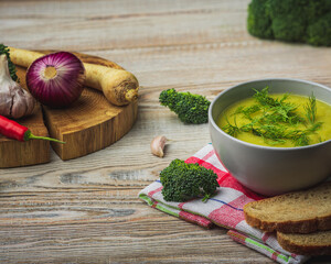 A vibrant array of vegetables and spices, including chili peppers, garlic, and broccoli, arranged...