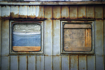 Wooden entrance of an abandone building in Ukraine, in the window colors of Ukrainian yellow and blue