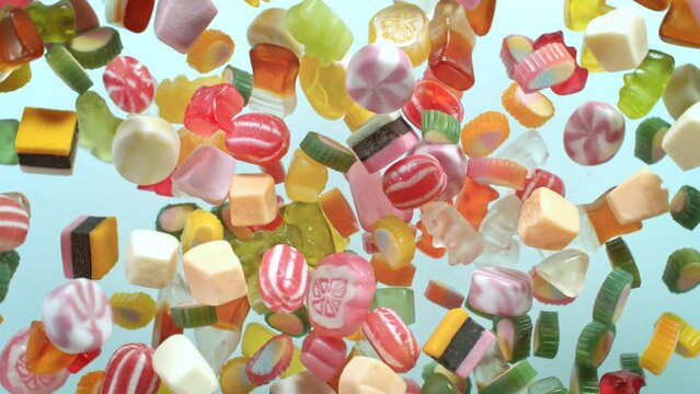 Super Slow Motion Shot of Sweet Colorful Candies Flying and Rotating Towards Camera at 1000fps.