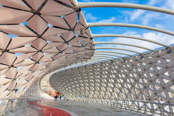 Modern architectural urbanistic Atyrau fish bridge across Ishim river. Pedestrian bridge with graceful fish scales interior, Nur-Sultan, Astana, Kazakhstan. High quality photo © lara-sh