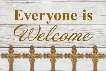 Everyone is welcome message with bronze religious cross on wood