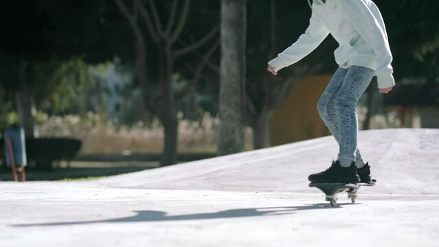 Girl riding on waveboard with two wheels, modern street skate sports of teenagers, casterboard or ripstick for balance ride.