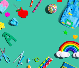 School supplies with a rainbow - overhead view - flat lay