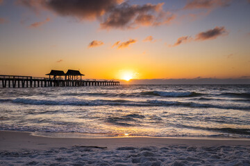 Sun setting at Naples pier post hurricane Ian Naples, Florida USA November 2022