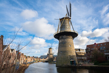 Classic view of traditional Dutch windmills in the historic city of Schiedam, Netherlands. In the...